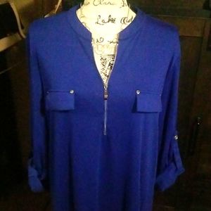 Royal blue top with silver button and zipper details.